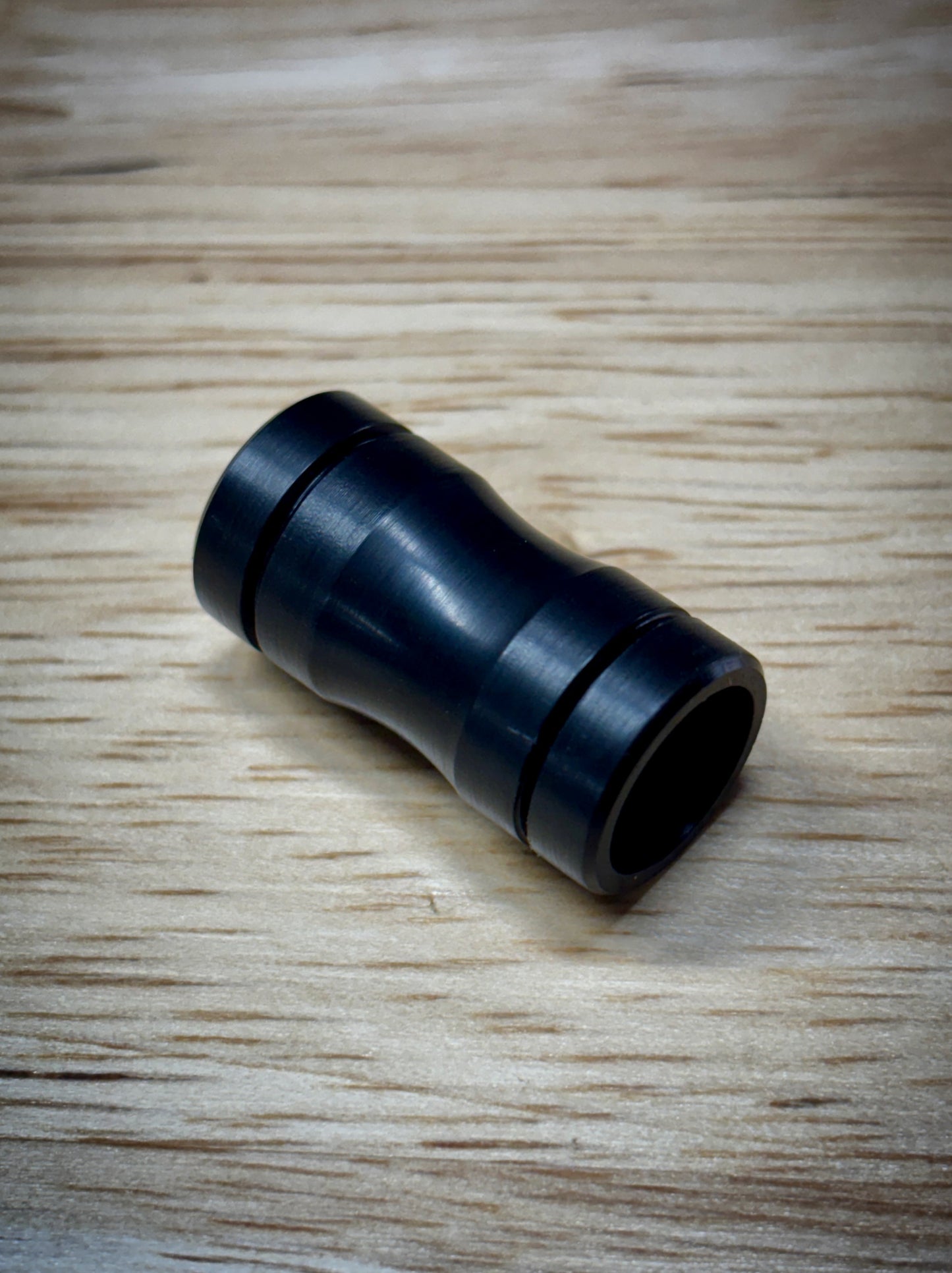 Black Delrin sleeve for The Simrell